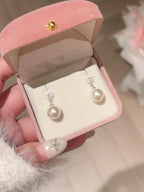 Shopimist pearl drop earrings featuring elegant white pearls hanging from delicate gold hooks.