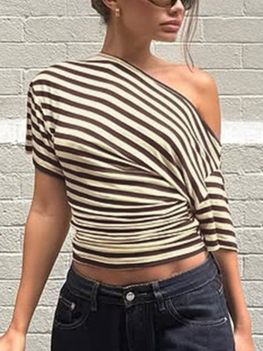 Women's striped one-shoulder T-shirt by Trendsi featuring an asymmetrical design and comfortable fit in a casual style.
