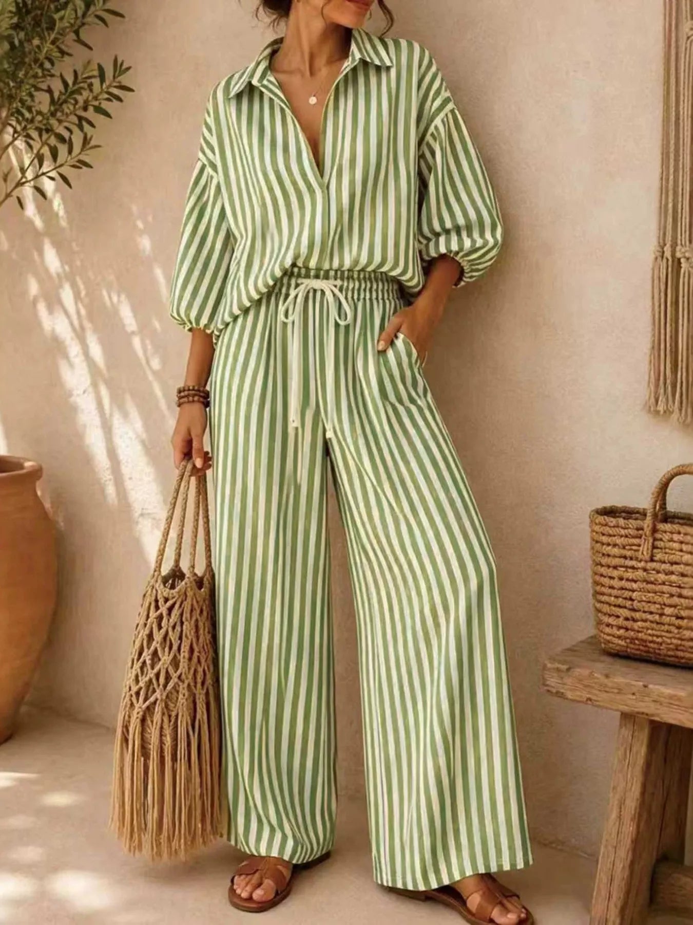 Plus size striped puff sleeve shirt and wide-leg drawstring pants set by Trendsi, featuring comfortable, stylish matching fabric.