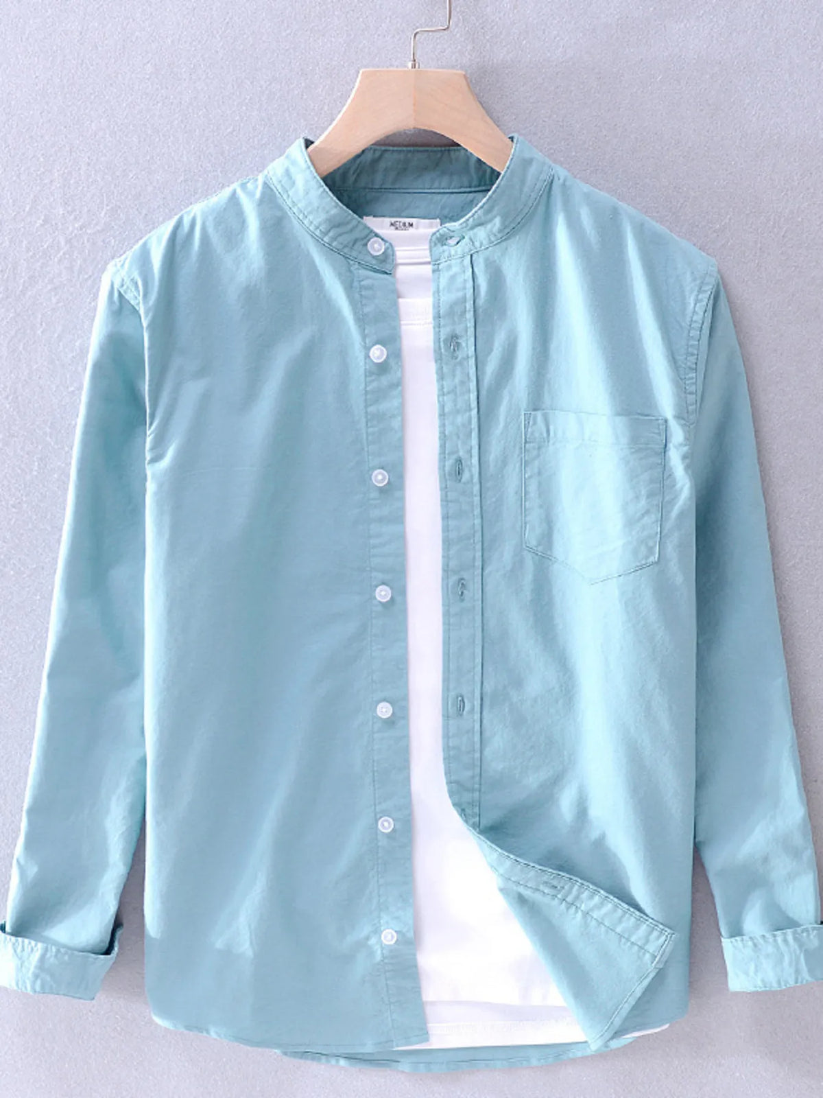 Men's plus size button-up long sleeve shirt by Trendsi, featuring a classic design and comfortable fit, shown in the image.
