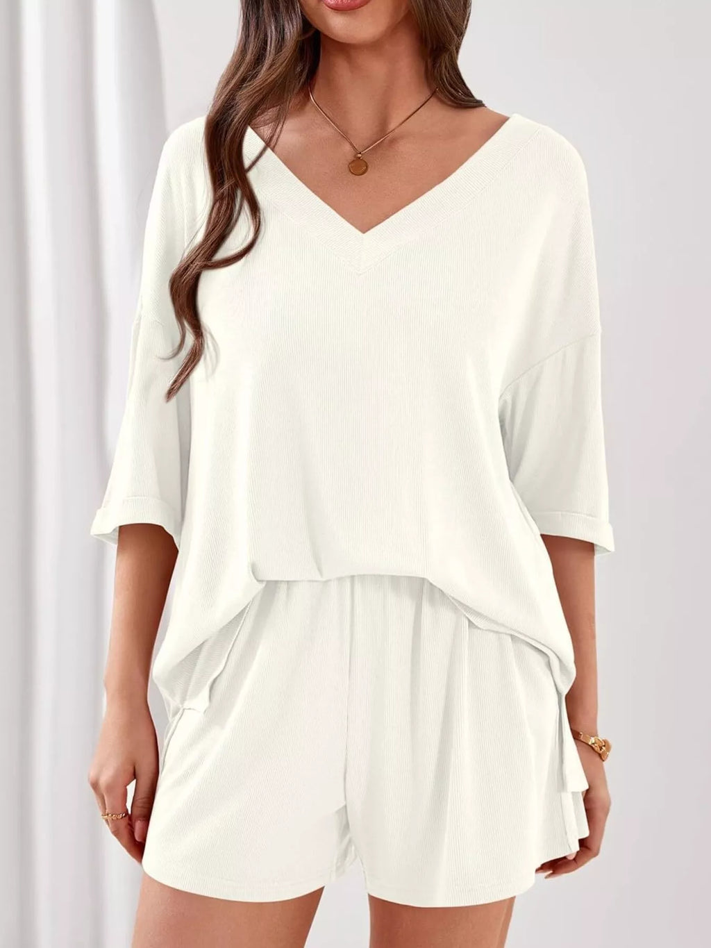 Women's casual V-neck top and shorts set by Trendsi, solid color two-piece outfit, perfect for everyday wear.