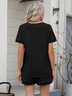 Solid color short sleeve top and shorts two-piece set by Trendsi, casual summer outfit, lightweight fabric, relaxed fit.