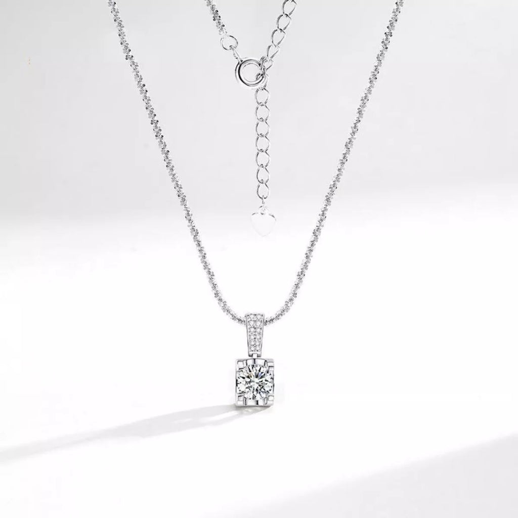 Sterling silver moissanite necklace with 1-carat center stone, elegant jewelry piece by Shopimist, showcasing the sparkling gemstone.