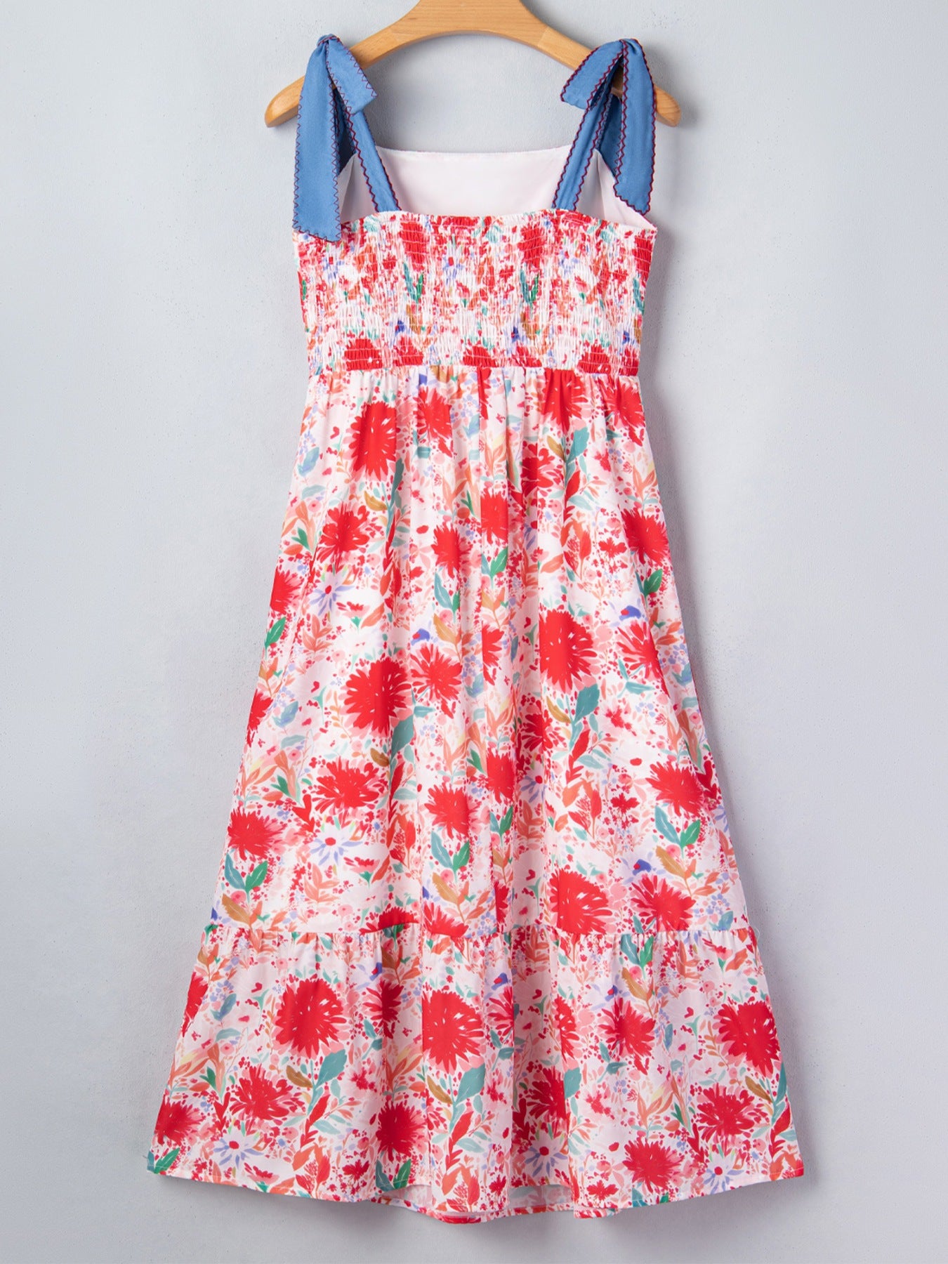 Floral print tie-shoulder midi dress with pockets, lightweight summer dress by Trendsi, featuring a flowy fit and vibrant floral design.