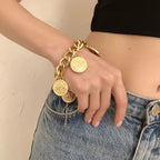 18K gold-plated coin charm bracelet with intricate coin details and delicate chain, stylish jewelry accessory.