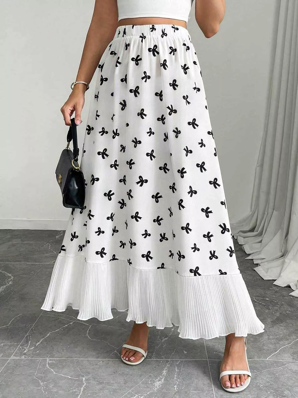 Flowy maxi skirt with bow print and ruffle hem from Trendsi, featuring a lightweight, flowy fabric and stylish design.