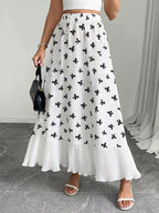 Flowy maxi skirt with bow print and ruffle hem from Trendsi, featuring a lightweight, flowy fabric and stylish design.