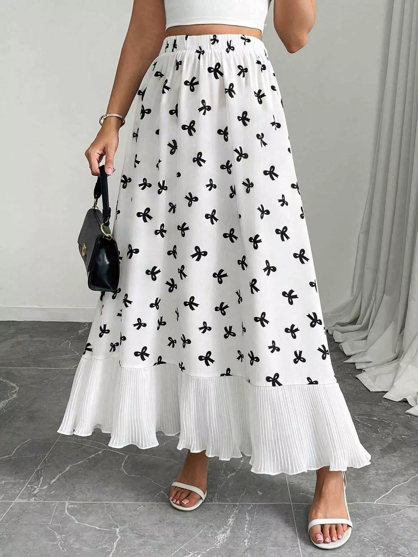 Flowy maxi skirt with bow print and ruffle hem from Trendsi, featuring a lightweight, flowy fabric and stylish design.