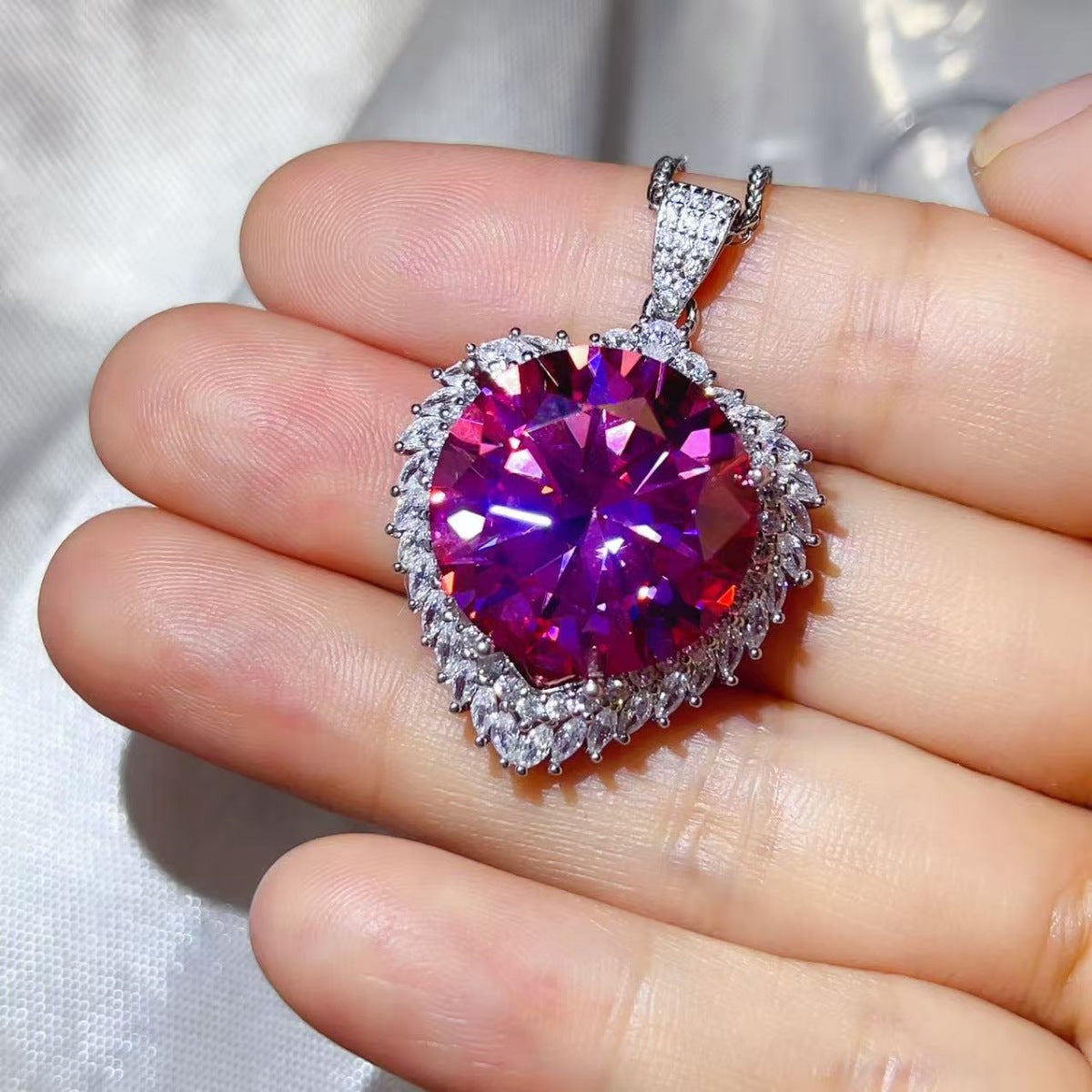 Sterling silver pendant necklace with a 20 carat moissanite gemstone, showcasing elegant jewelry design and sparkle.