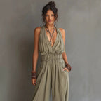 Women's sleeveless V-neck halter jumpsuit with open back and waist cinching from Plush Fashion Hub.