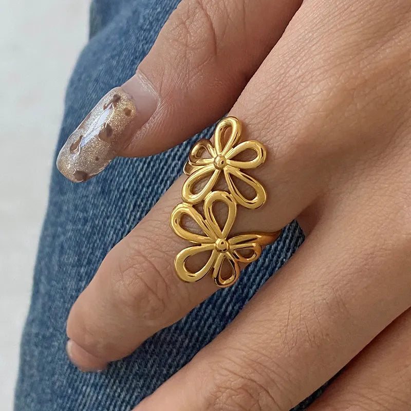 Stainless steel flower ring from Plush Fashion Hub featuring a detailed floral design on a sleek band.
