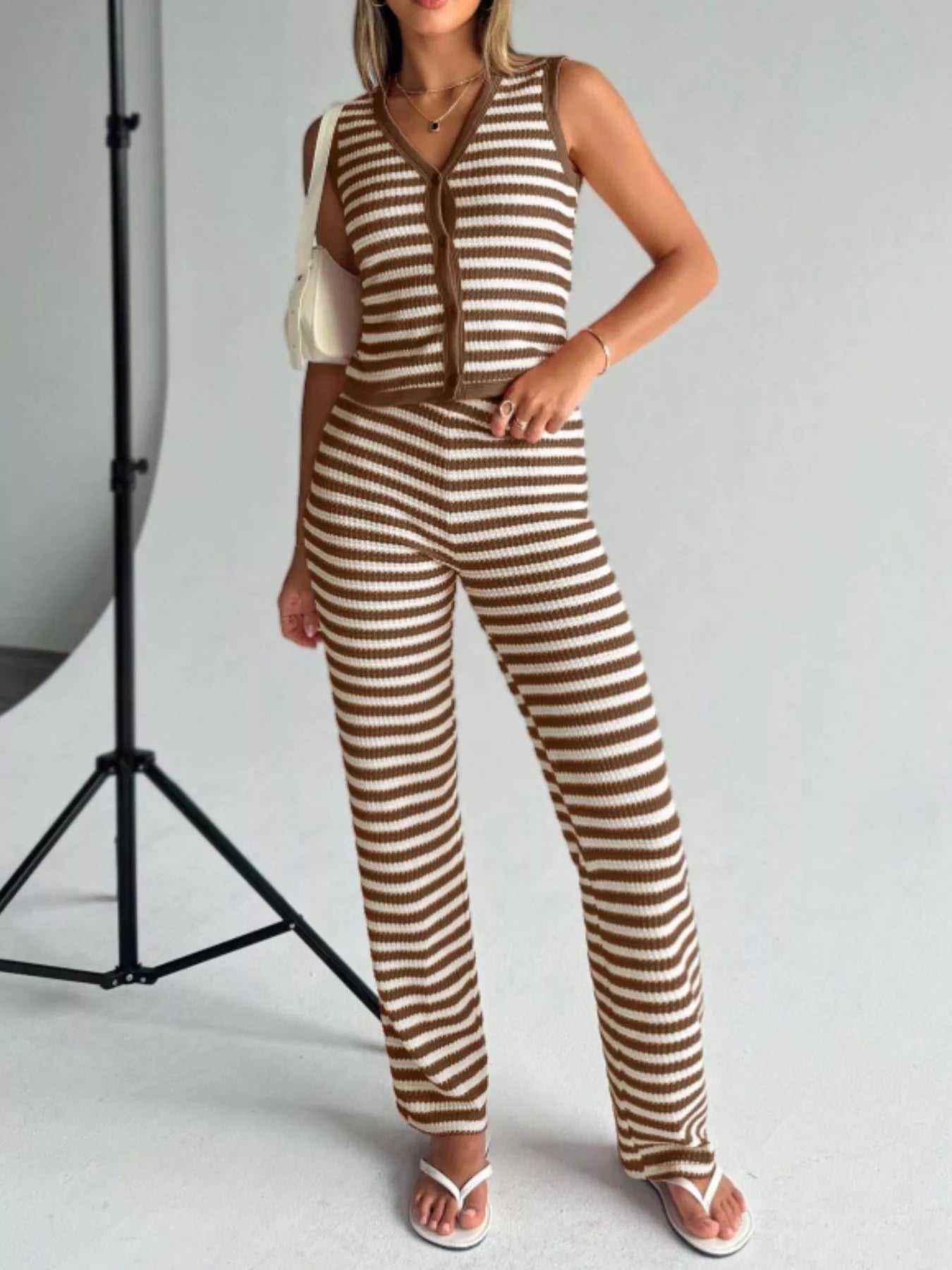 Striped knit V-neck sleeveless top and flare pants set by Plush Fashion Hub, showing the stylish, fitted top and flowing pants.