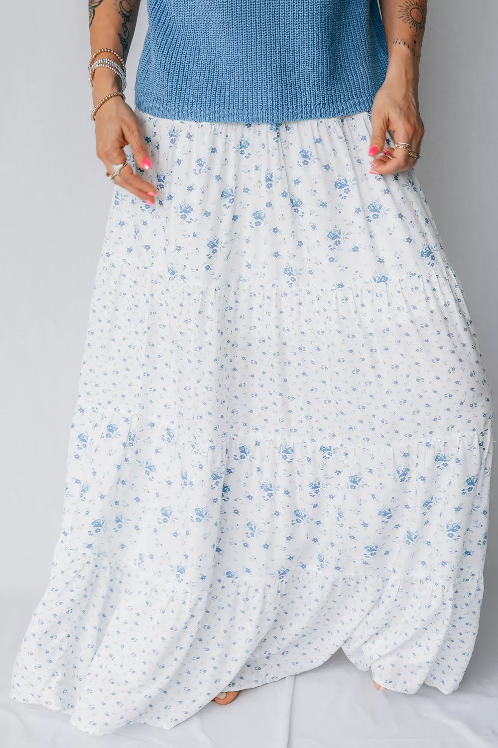 Women's high waisted floral boho maxi skirt with a flowy tiered design made of viscose fabric, perfect for bohemian style.