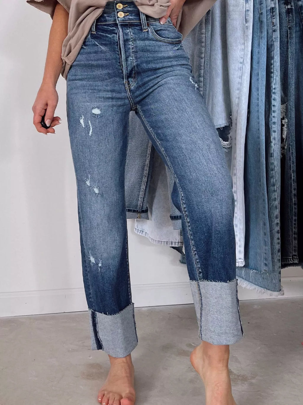 High waist distressed straight leg jeans by Trendsi, showing fit and ripped details on light denim fabric.