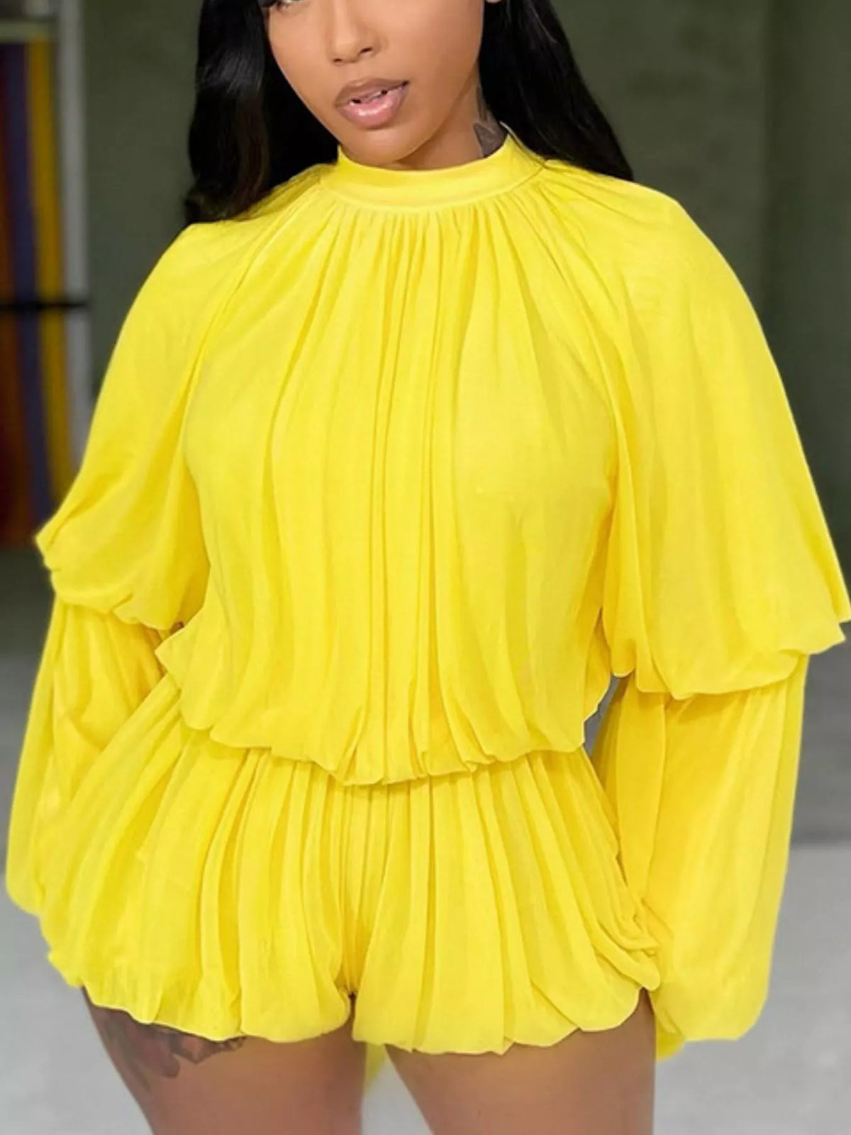 Elegant pleated bell sleeve romper by Trendsi featuring a stylish design with flowing fabric and a flattering fit.