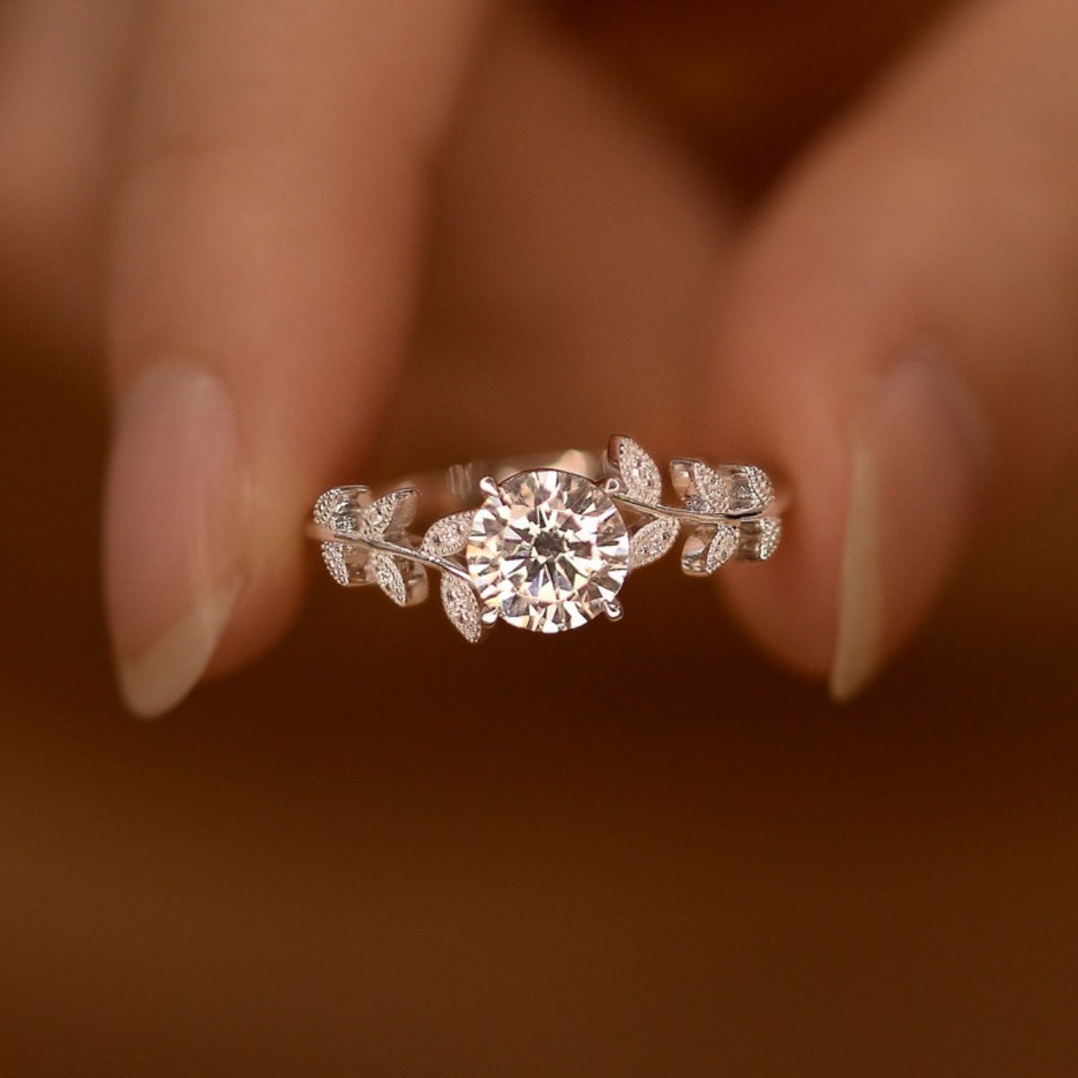 Sterling silver leaf ring with 1 carat moissanite gemstone, elegant jewelry piece from Plush Fashion Hub.