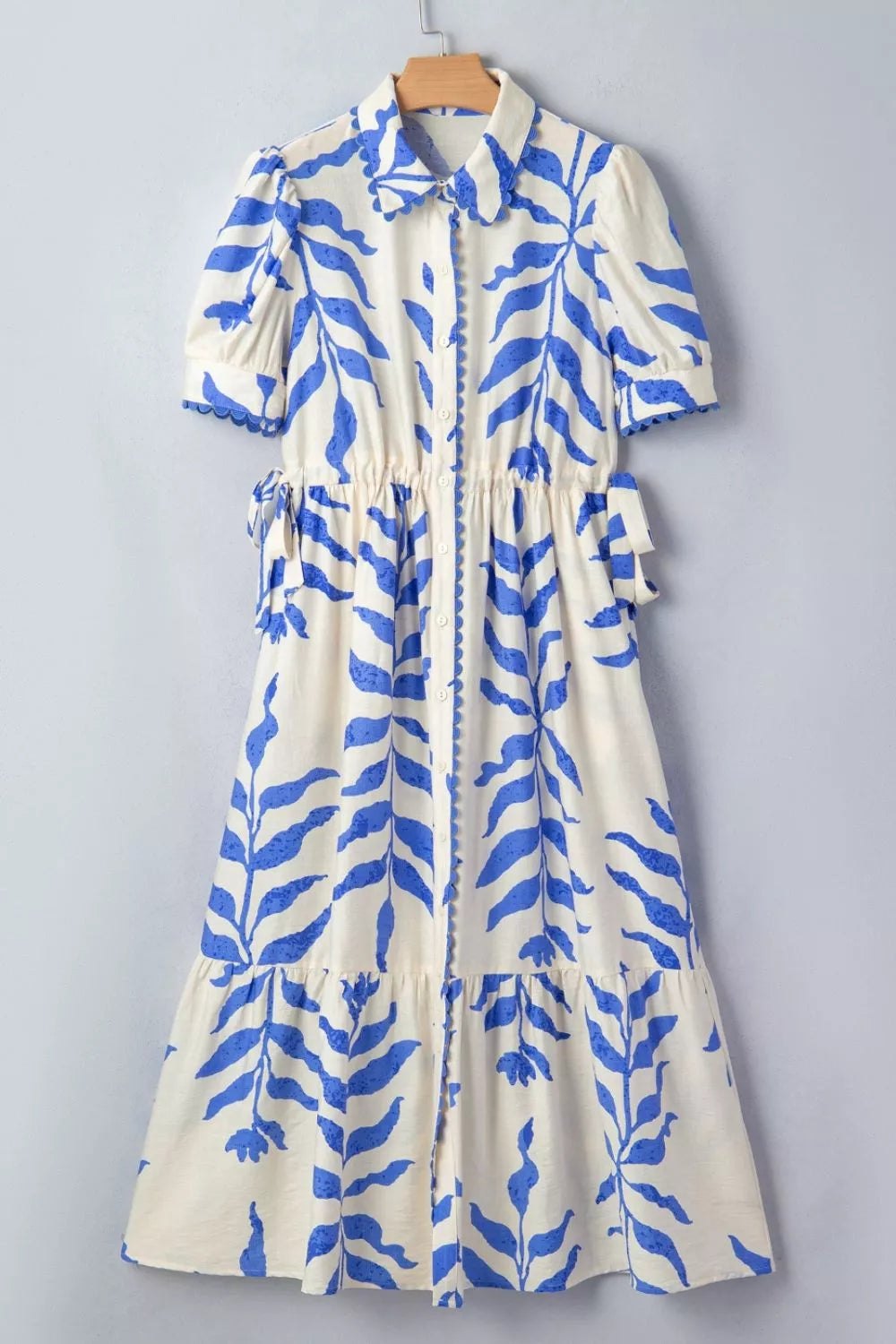 Leafy botanical print maxi dress with side tie and button-down front, by Shopimist, displayed on a model.