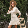 Women's V-neck A-line casual dress by FitiqueFit with three-quarter sleeves and button contrast panel, displayed on a hanger.