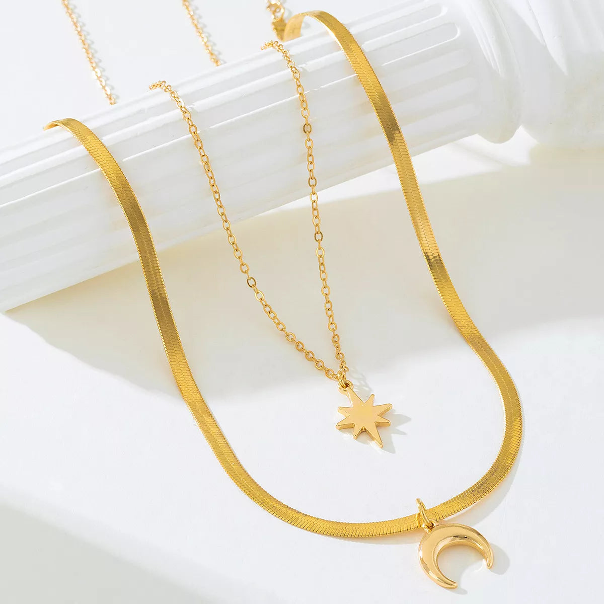 Gold-plated moon and star necklace set with matching pendants, featuring a delicate design in gold finish for elegant style.