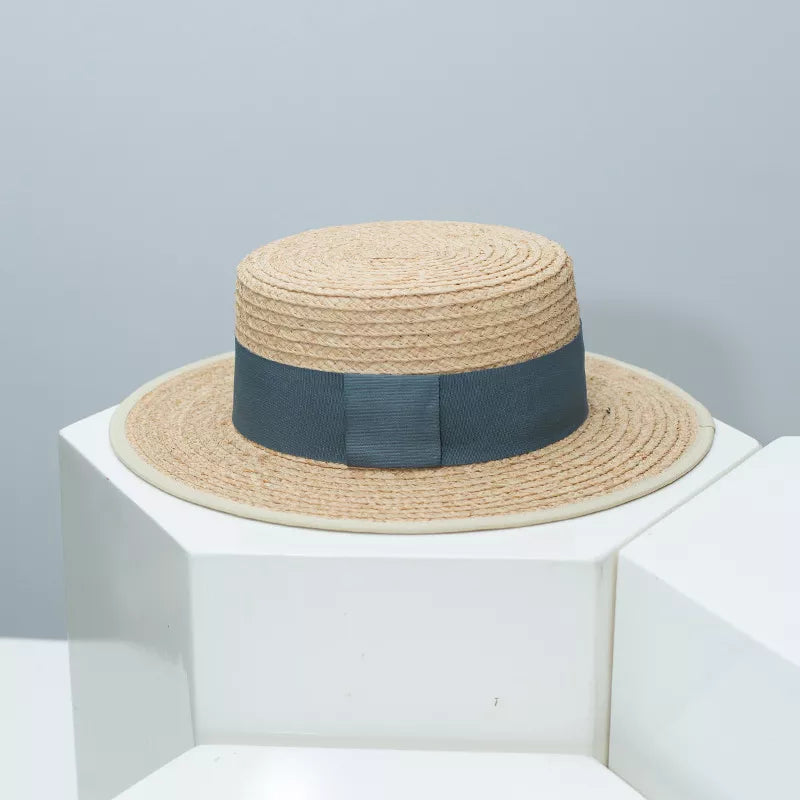Straw boater hat with black contrast band, lightweight summer accessory, from Plush Fashion Hub, featuring a classic straw hat design.