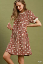 Umgee floral textured puff sleeve mini dress with a fitted bodice and ruffled hem, perfect for spring and summer wear.