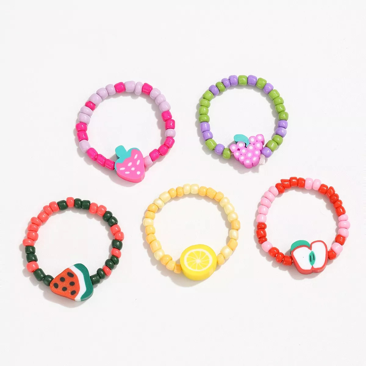 Colorful fruit charm beaded ring from Plush Fashion Hub featuring vibrant fruit-shaped beads on a silver band.