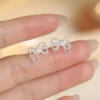 Sterling silver bow knot stud earrings with a polished finish, featuring a delicate and elegant design for everyday wear