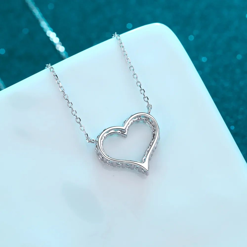 Sterling silver heart-shaped moissanite necklace with delicate chain, elegant jewelry piece from Plush Fashion Hub.
