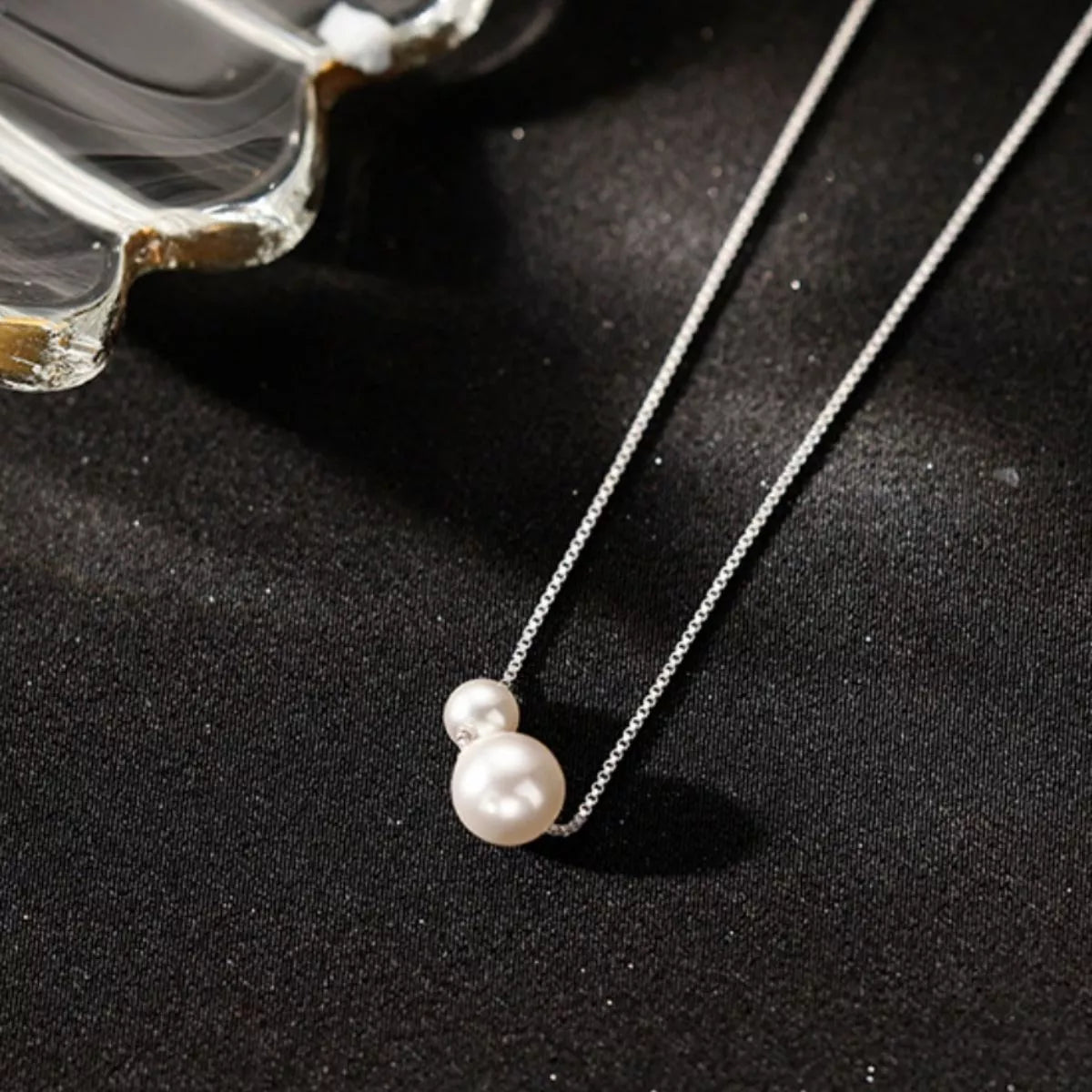 Sterling silver pearl necklace with a delicate chain and lustrous white pearls, elegant jewelry by Shopimist.