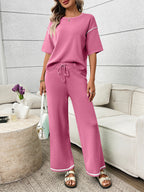 Women's casual two-piece lounge set with round neck top and drawstring pants, stylish and comfortable by Trendsi.