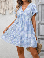 Plush Fashion Hub plaid V-neck mini dress with ruffle hem, lightweight fabric, perfect for seasonal fashion and casual outings.