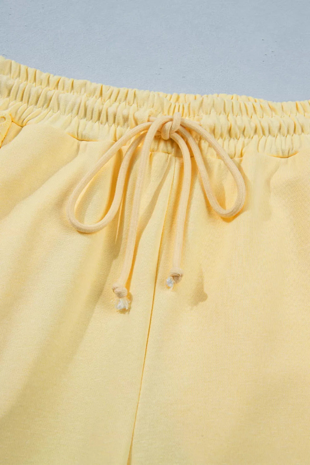 Plush Fashion Hub half sleeve top and drawstring pants set with rings design, casual loungewear for women.