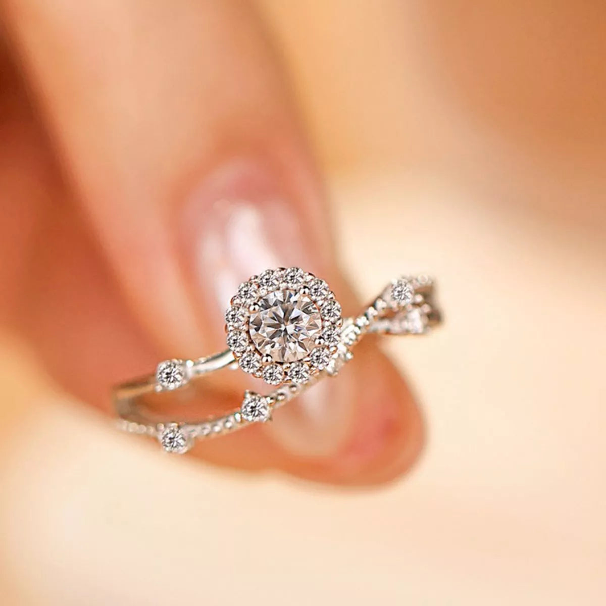 Sterling silver layered ring with a 1-carat moissanite gemstone, featuring intricate design and polished finish.