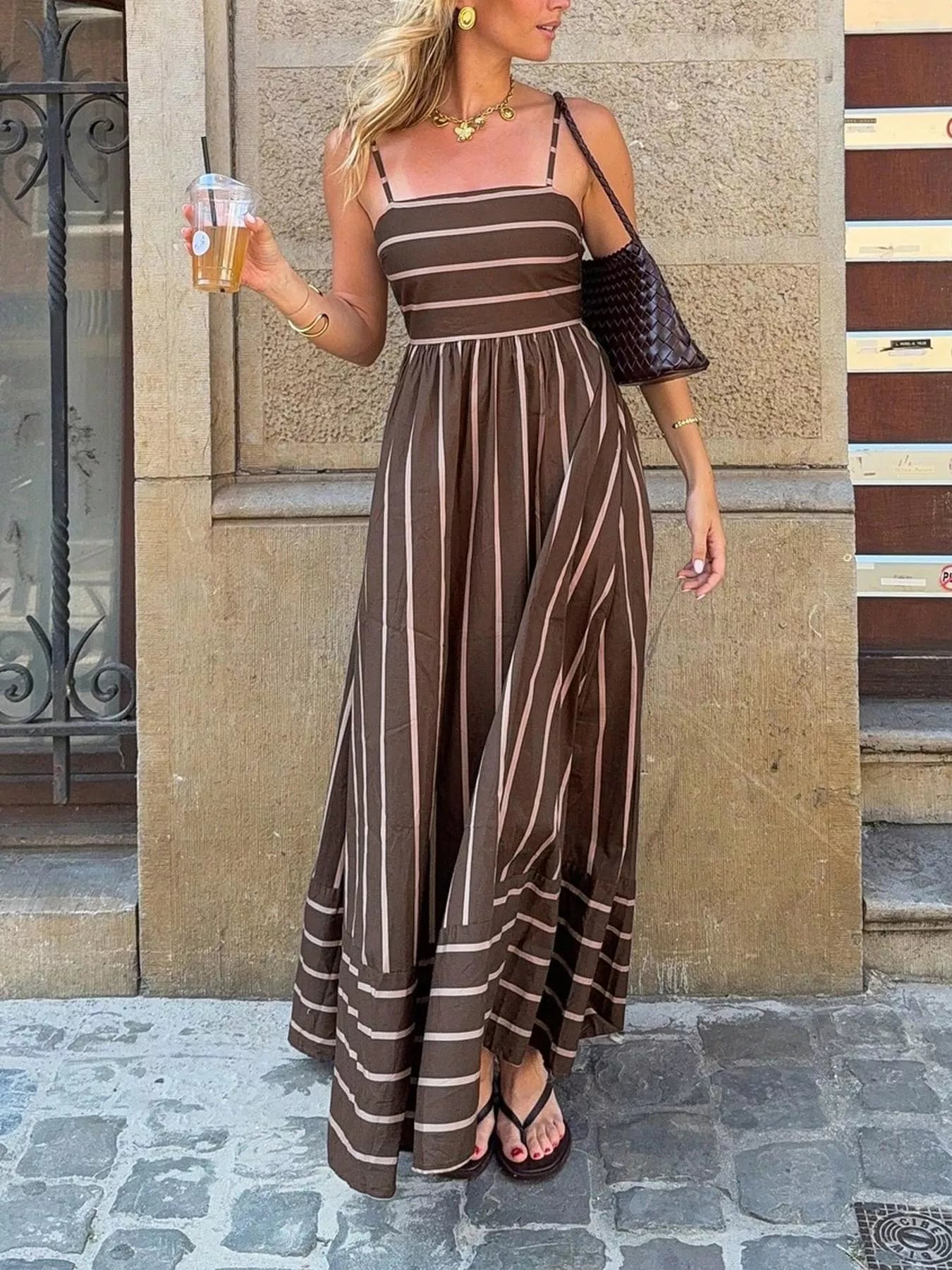 Striped cutout back maxi dress by Plush Fashion Hub featuring bold horizontal stripes and a stylish back cutout detail.