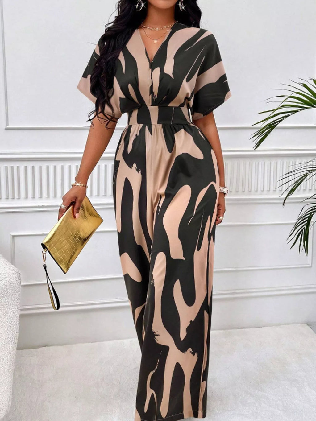 Abstract print wide-leg jumpsuit by Trendsi, featuring flowing fabric and stylish design, shown in a full-length image.