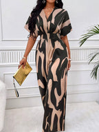 Abstract print wide-leg jumpsuit by Trendsi, featuring flowing fabric and stylish design, shown in a full-length image.