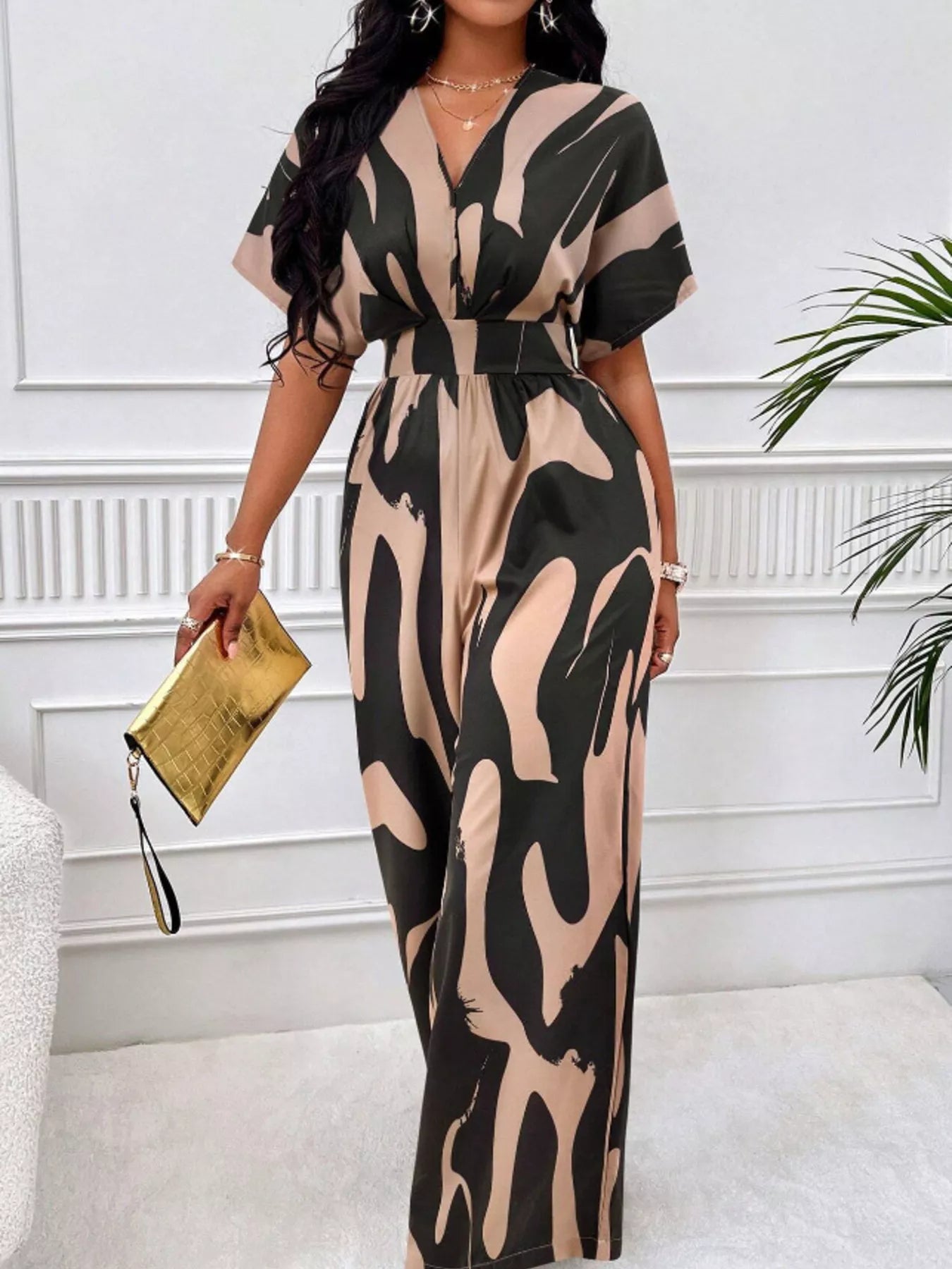 Abstract print wide-leg jumpsuit by Trendsi, featuring flowing fabric and stylish design, shown in a full-length image.