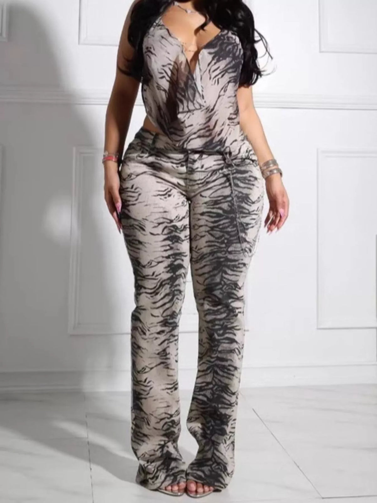 Women's animal print sleeveless top and pants set by Trendsi, featuring a stylish, coordinated fashion look with bold print details.