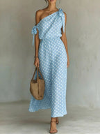 Plus size polka dot one-shoulder maxi dress by Trendsi, featuring a full-length flowing silhouette and stylish design.