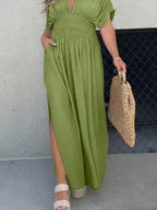 Plus size maxi dress with slit V-neck and smocked waist by Trendsi, featuring flowing fabric and elegant design.