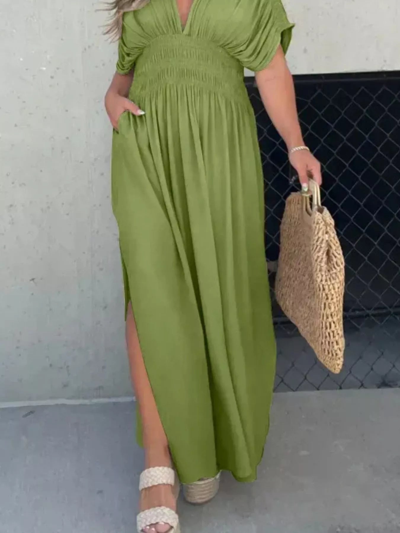 Plus size maxi dress with slit V-neck and smocked waist by Trendsi, featuring flowing fabric and elegant design.