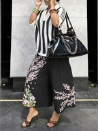 Women's wide-leg cargo pants with zipper and button details from Plush Fashion Hub, featuring a relaxed fit and functional pockets.
