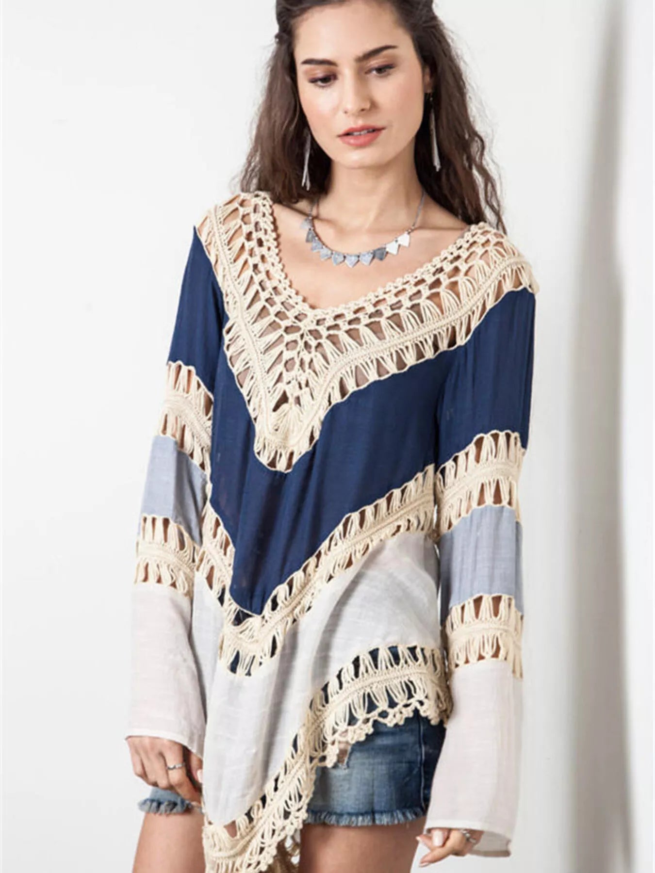 Crochet-trimmed long sleeve swimwear cover-up in lightweight fabric, designed for beach or poolside wear.