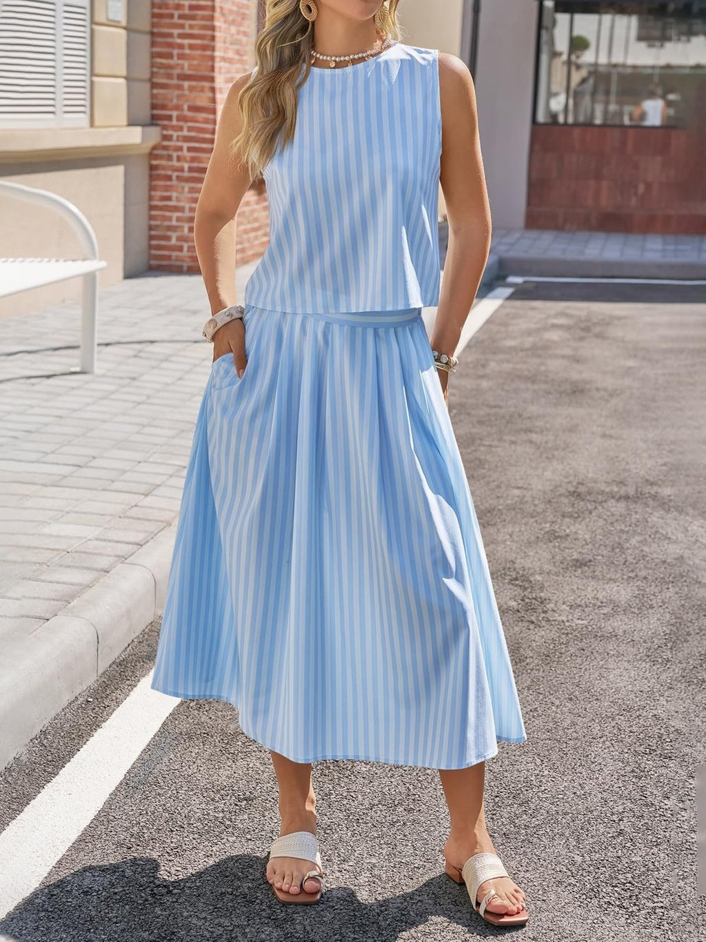 Women's striped sleeveless top and midi skirt two-piece set by Trendsi, featuring a stylish coordinated ensemble in vibrant patterns.