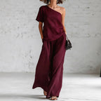 Women’s wide-leg pants and top set by FitiqueFit, casual 2-piece outfit with three-quarter sleeves, laid flat on a neutral background.