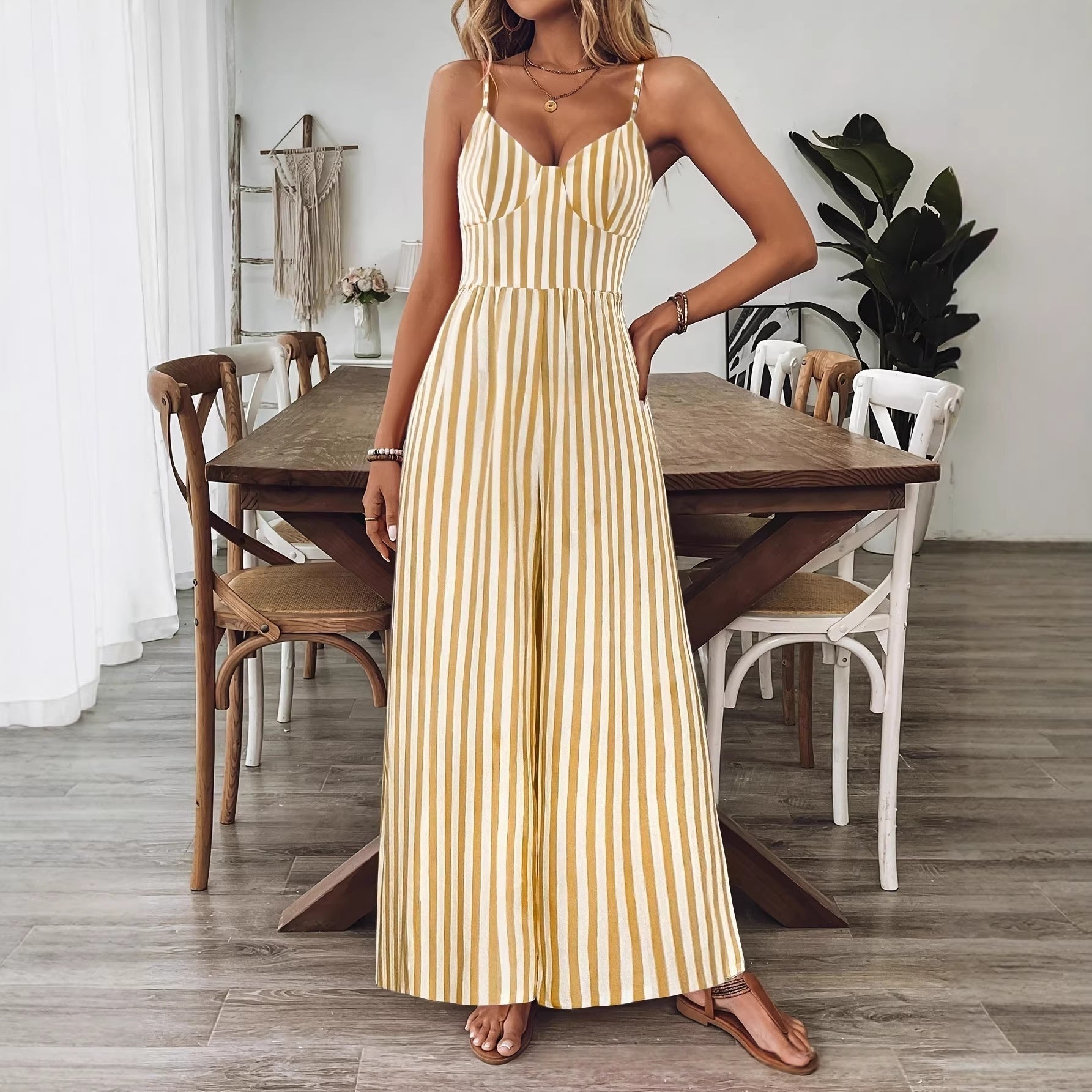 Ginger yellow printed backless sleeveless strap jumpsuit by FitiqueFit, featuring a relaxed fit and stylish design.