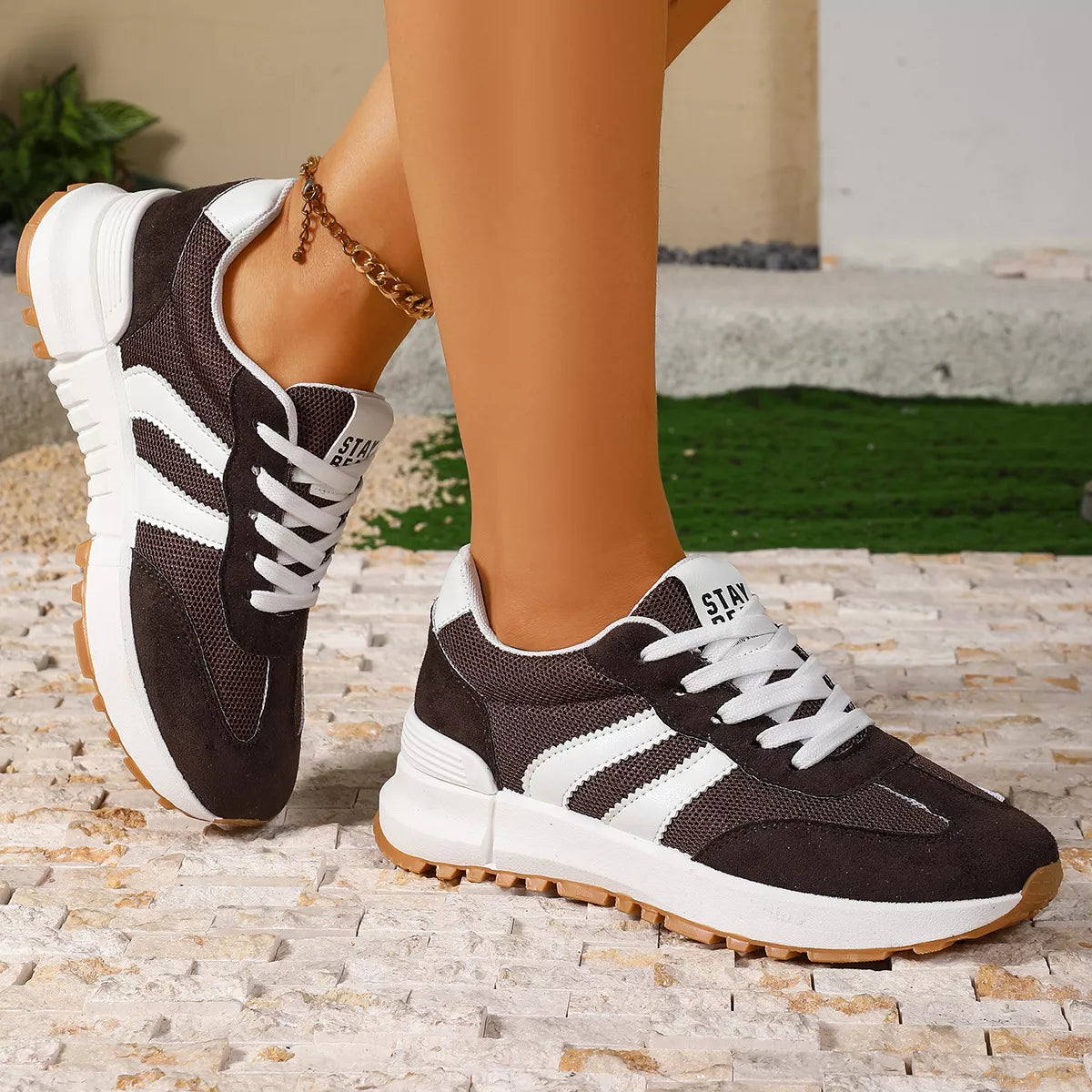 Women's round toe lace-up sneakers by Trendsi, featuring classic design and comfortable fit, shown in a stylish casual setting.