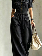 Plus size denim wide-leg jumpsuit with chest pockets, trendy casual jumpsuit from Trendsi, full-length front view.