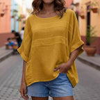 Loose-fitting LadyShow.Store crew neck top with three-quarter-length sleeves, shown in a natural, casual style.