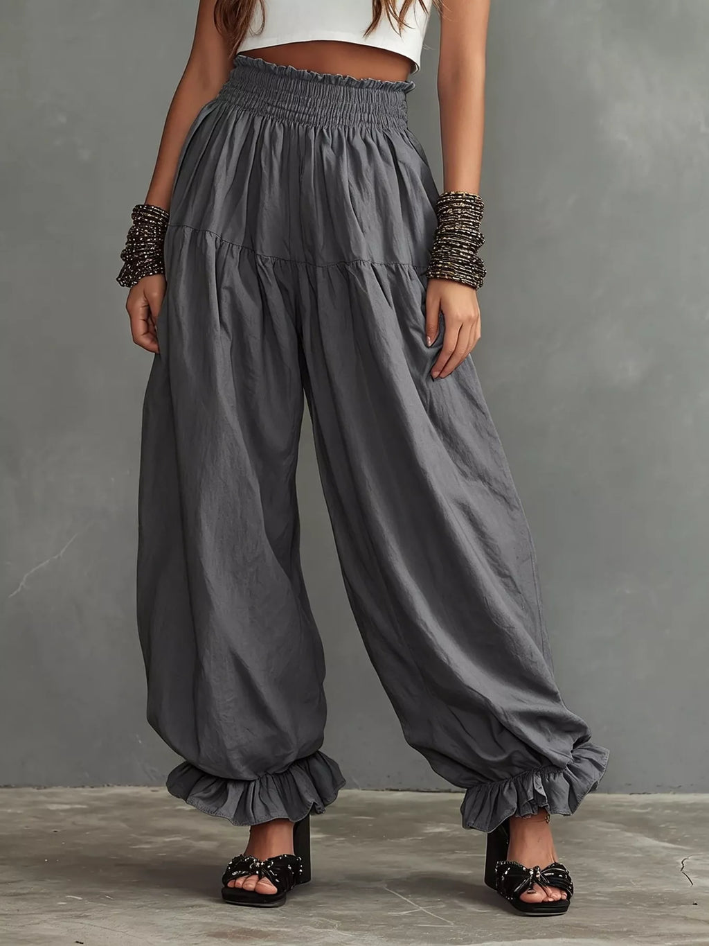 Full size smocked ruffle hem wide-leg pants from Trendsi, featuring flowing fabric and stylish ruffle details at the hem.